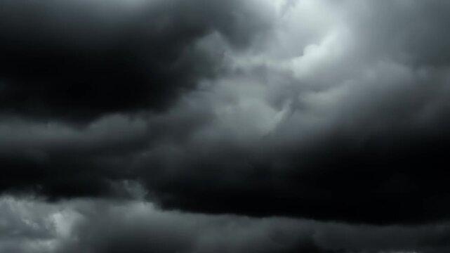 4K time lapse video of grey rainy clouds in film noir style. Grey stormy sky before rain. Vintage cinematic style, drama, thriller, horror. Black and white video in film noir style.