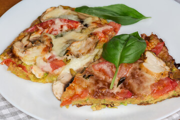 Zucchini pizza with chicken meat and mushrooms filling, close-up