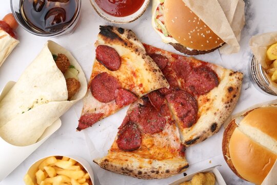 Different delicious fast food and soda drink on white marble table, flat lay - Powered by Adobe