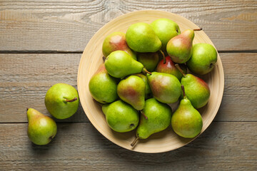 Fresh ripe pears on wooden table, flat lay