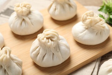Many uncooked khinkalis (dumplings) on table, closeup