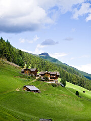 Alpine meadows and farmhouses in South Tyrol, northern Italy, panoramic view.