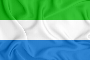 flag of the Republic of Sierra Leone with three horizontal stripes on satin fabric with folds and shadows