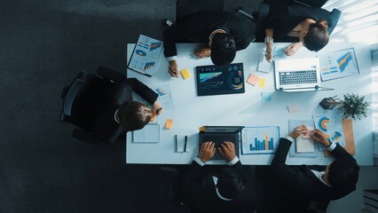 Top down aerial view of business people brainstorm financial plan by using colorful sticky notes at meeting while businessman looking at financial statistic and analyze financial data. Directorate. © InfiniteFlow