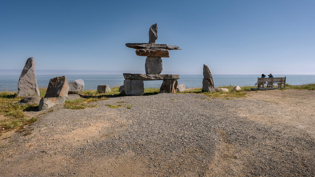 Inuksuk (inukshuk) on the shore of Hudson Bay at Churchill, Manitoba, Canada