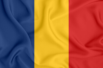 flag of the Republic of Chad with three vertical stripes on satin fabric with folds and shadows