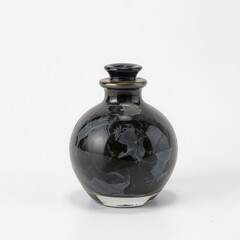 A small round dark ceramic bottle with a textured surface and a stopper sits on a white background