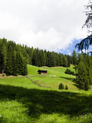 Rural South Tyrol landscape with mountains and blue sky in summer.