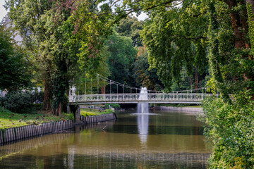 Naklejka premium Beveren, Belgium – August 6, 2025: Close detail of bridge and moat at Castle Cortewalle. 