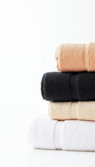 Studio shot of neatly stacked colorful towels on white background