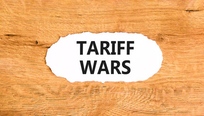 Trade tariff wars symbol. Concept word Tariff wars on beautiful white paper. Beautiful wooden paper...