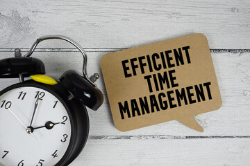 Efficient Time Management text with alarm clock on wooden background