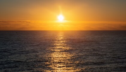 Obraz premium scene serene beauty of sun sinking into ocean casting a golden glow and creating a peaceful atmosphere