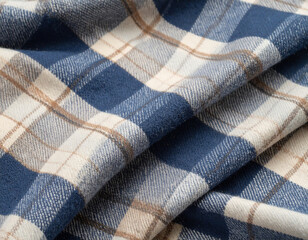 Close-up of soft plaid fabric in blue, beige and white tones with a checkered pattern. Cozy textile texture, warm material ideal for clothing, blankets or interior decoration.