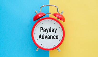 A red alarm clock with the words Pay day Advance written on it. The clock is set to the time