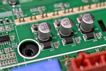 Close-up of rectifier diodes next to capacitors on a printed circuit board.
