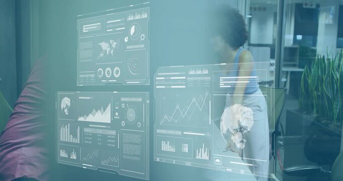 Woman powering laptop on table, holographic charts emerging for business analysis with colleague