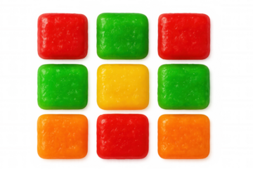 Colorful fruit candies aligned symmetrically on clear surface, displaying sweet geometric arrangement