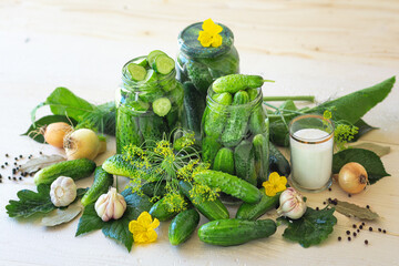 Salted homemade cucumbers in jars on a wooden natural background. Pickled cucumbers with dill, garlic, onion and spices. Canned cucumbers. Cucumbers with dill. Recipe for home canning. Canning and pre