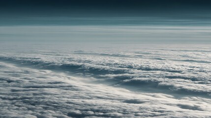 A vast expanse of cumulus clouds, seen from an elevated perspective, displays a textured landscape of swirling formations against a serene, light-toned sky.