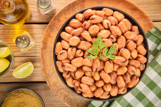 Arabic Cuisine; Egyptian traditional dish " Ful Medames". Middle Eastern breakfast with plain fava beans bowl served with fresh lemon, cumin and olive oil.