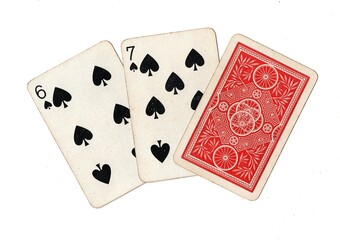 A hand of three vintage playing cards with two cards revealed on a white background.