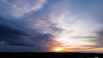 Fototapeta premium Awesome spring sunset sky over forest