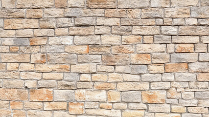 Obraz premium Tan Stone Wall Texture presents rough surfaces. Good for backdrops, wallpaper, or presentations.