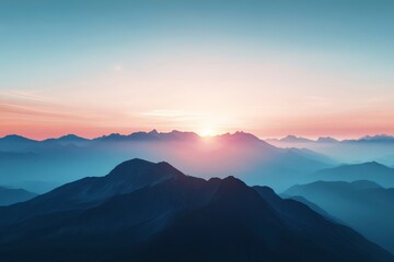 Obraz premium The mountains are covered in a blue mist and the sun is setting behind them