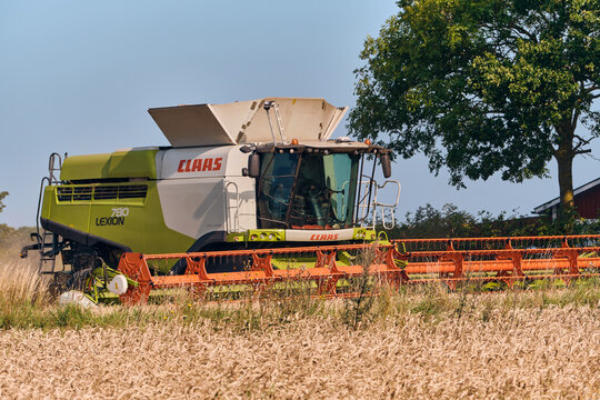Claas Lexion 780 combine harvester working in wheat field, Scania, Sweden