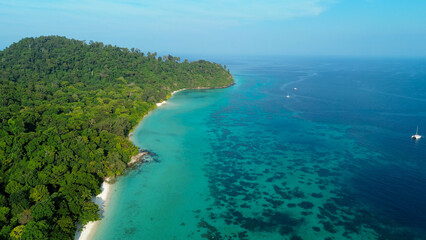 Fototapeta premium Beautiful tropical islands of Koh Rok in the south of Thailand. Green islands with cliffs, turquoise water near the shore and white beaches.
