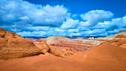 Fototapeta premium Red Sandstone Formations and Dramatic Clouds Paria Canyon Ground Level