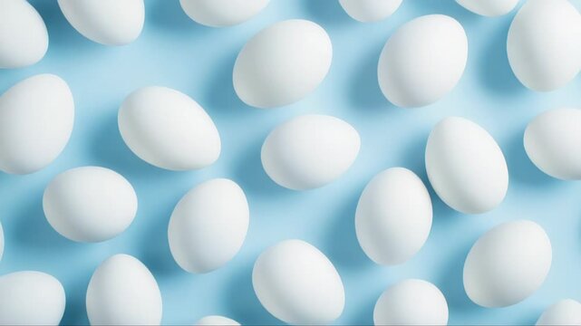 Pristine white eggs creating geometric pattern across soft pastel blue surface, representing minimalist easter design concept with clean aesthetic