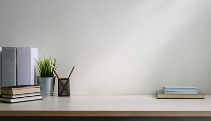 workspace office table empty desk with books and supplies against the white wall copy space for text or product showcase