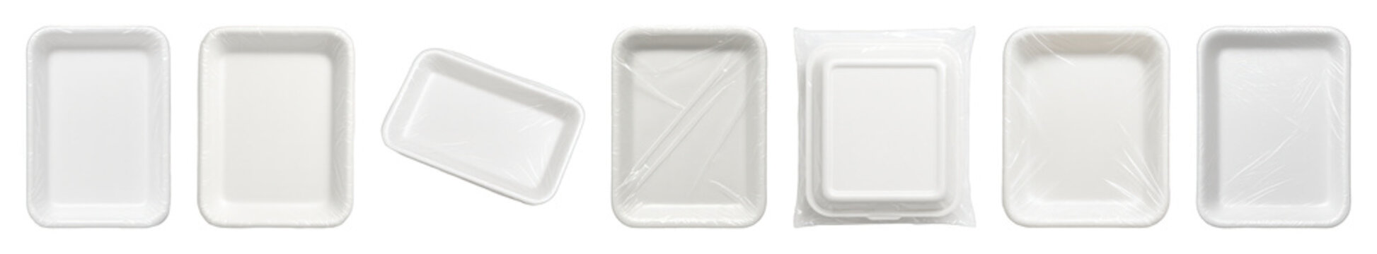 White polystyrene food tray set including empty, film-wrapped, stacked, and angled variations isolated. Food packaging.