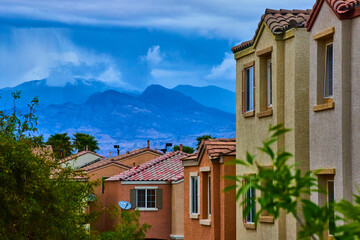 Suburban Las Vegas Homes with Stormy Mountains and Lush Greenery