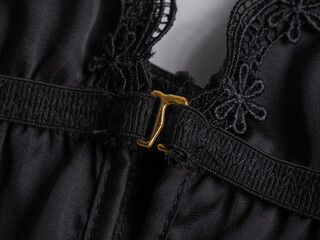 Close up of black fabric and gold clasp on women's underwear