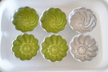 Finished Green Apple Jelly in Flower Shaped Metal Molds, Homemade Fruity Agar Dessert with Refreshing Summer Taste