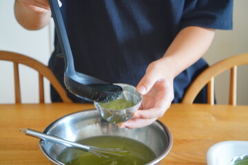 Pouring Green Apple Jelly Mixture into Flower Shaped Molds, Homemade Fruit Flavored Agar Dessert Preparation Process