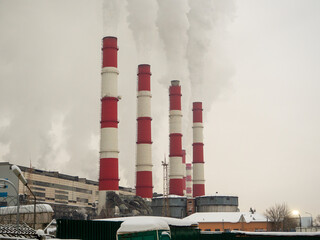 Close-up of the smoking pipes of a thermal power plant. Environmental pollution