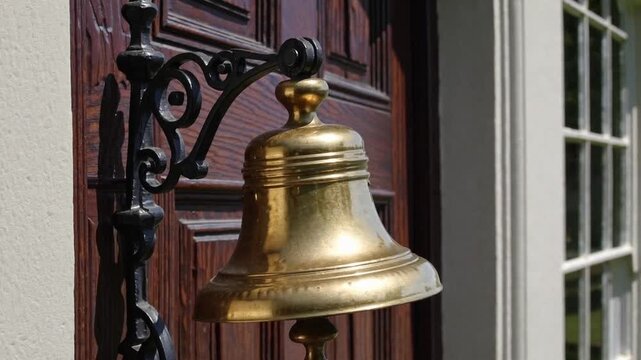 old golden bell hanging prominently in front of doorway