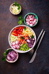 Balanced healthy bowl with vegetables and salmon