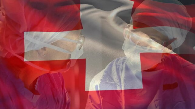 Two surgeons adjusting mask and consulting for surgery under transparent Swiss flag overlay