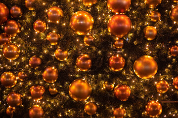 New Year Christmas background of golden decorative balls on a Christmas tree