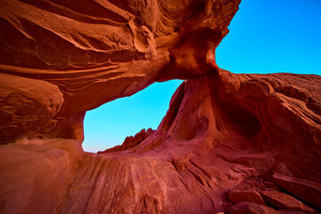 Red Rock Arch Formation and Eroded Sandstone under Clear Blue Sky