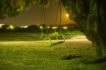 Swing on the beach during a night walk. © Krzysztof