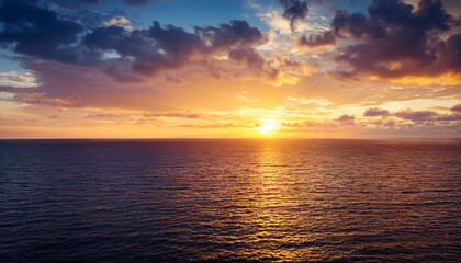 Obraz premium serene sunset over tranquil sea with golden horizon and breathtaking dramatic cloudscape nature scenic