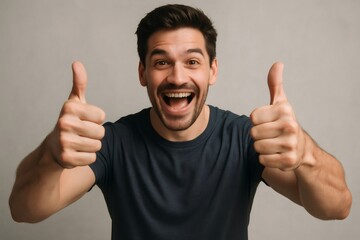 Excited man showing double thumbs up gesture, expressing positivity and approval on a neutral background