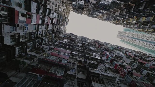 View of overcrowded high-rise slum buildings symbolizing urban poverty and social inequality. Concept of overpopulation, poor living conditions, housing crisis and contrast of modern city life.