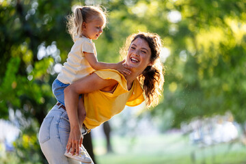 Mother and daughter share joyful moments outdoors